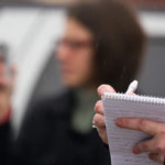 Reporter taking notes in a notebook