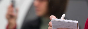Reporter taking notes in a notebook